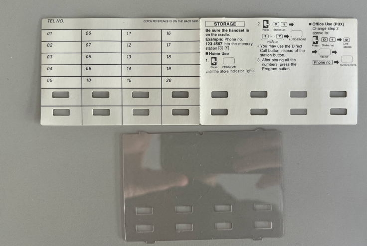 Panasonic phone with flipped label card showing fresh white surface