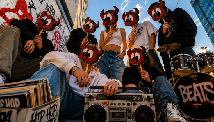 Group of people holding FreeBSD daemon masks in an urban city setting