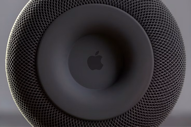 Apple logo centered on the circular top surface of a black HomePod