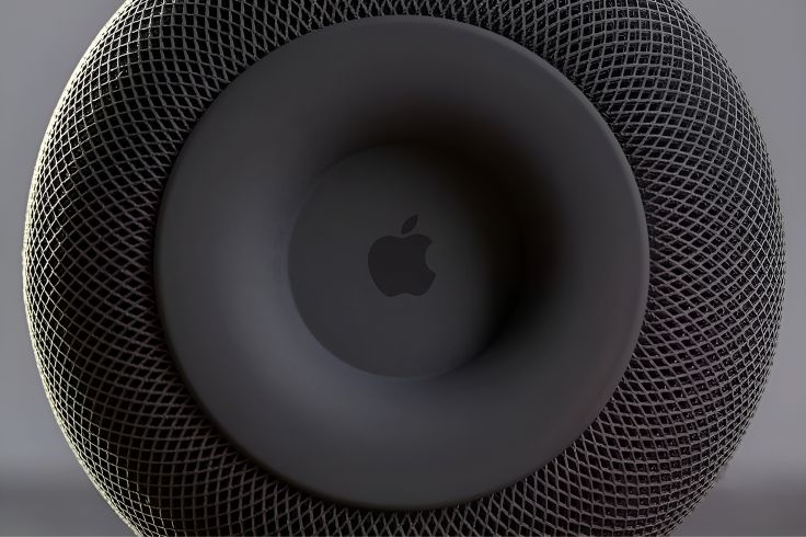 Apple logo centered on the circular top surface of a black HomePod
