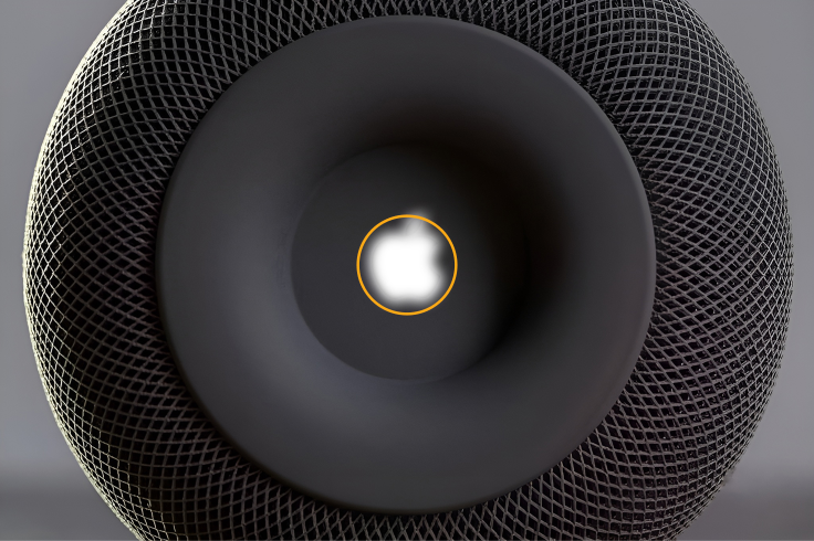 Blurred Apple logo mass aligned inside an orange center circle on the HomePod